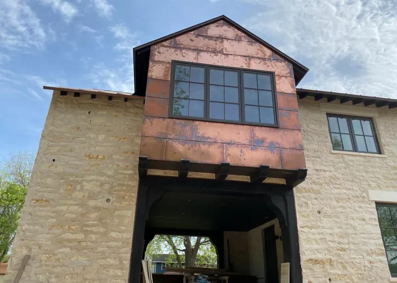 Copper metal panel facade on a stone building for Roof Repair in Safford