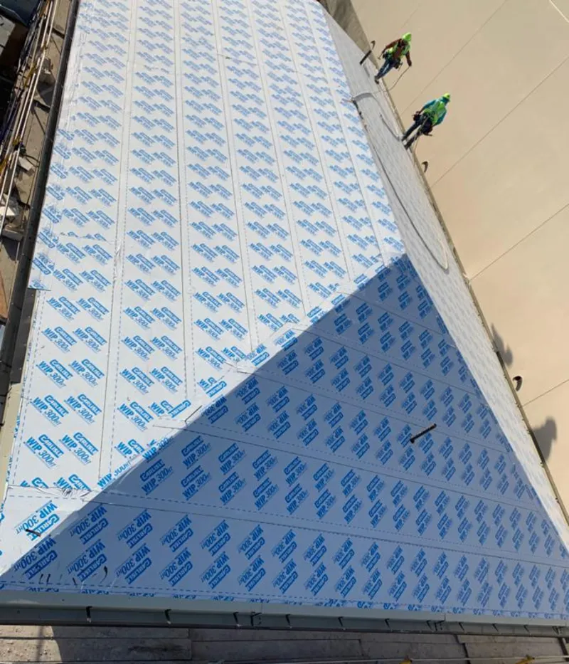 Professional roofers installing underlayment on a metal roof in Safford